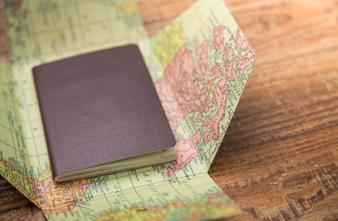 Blank passport with Map on wood table